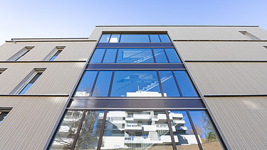Außenansicht Gebäude Safranberg mit Holzfassade Außenansicht Gebäude Safranberg mit attraktiver vorvergrauter Holzfassade